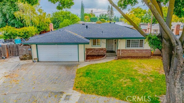 a front view of a house with a garden and trees