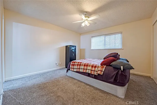 a bed sitting in a bedroom next to a lamp