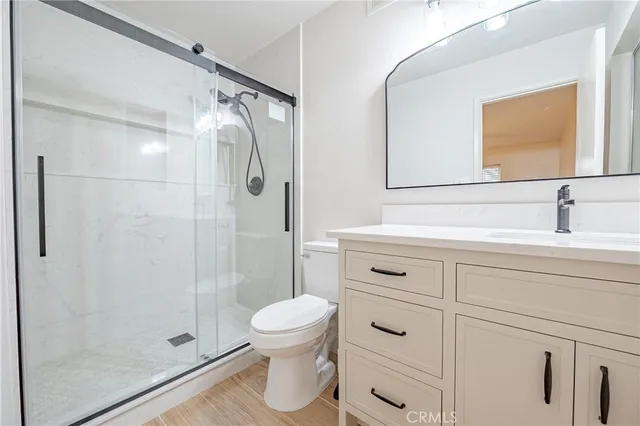 a bathroom with a shower toilet and sink