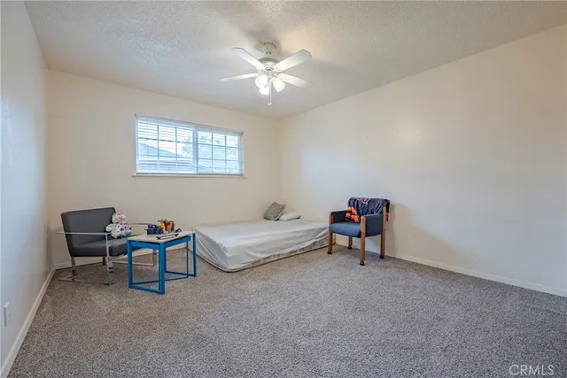 a living room with furniture and a ceiling fan