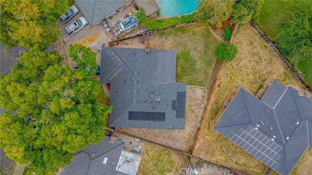 an aerial view of a house with a yard