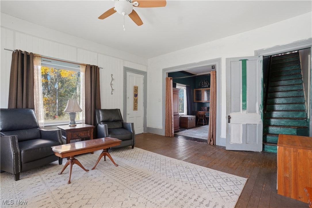 884 Brownville Road Rome, OH 44085 - Photo 12 of 36 Sitting room featuring dark wood-style floors, plenty of natural light, ceiling fan, and stairs