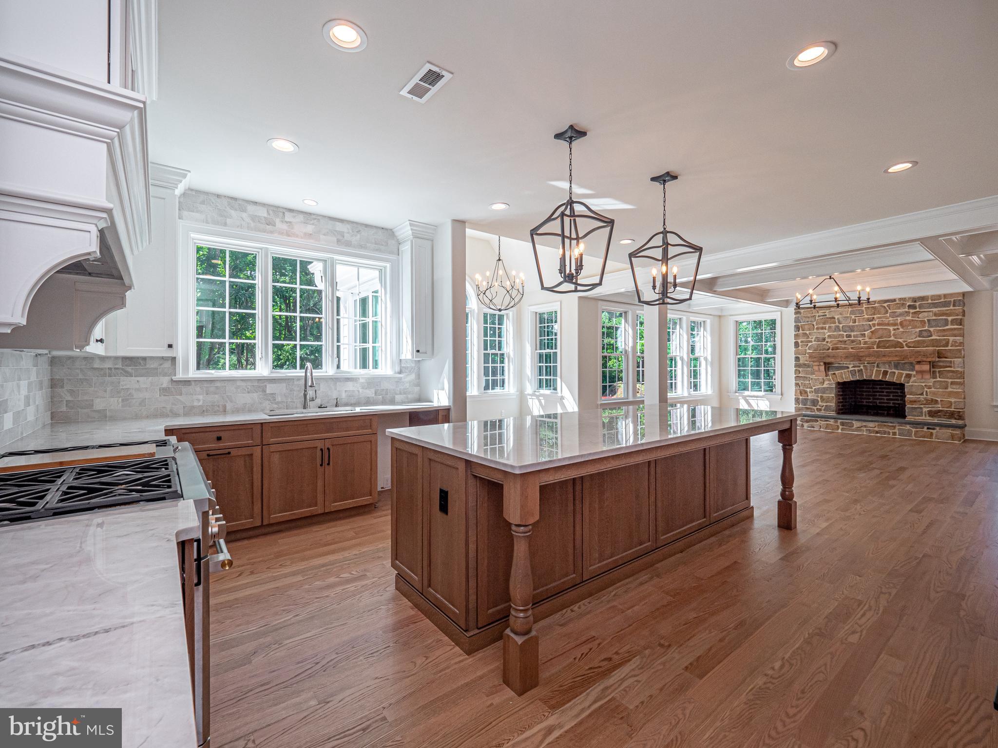 a kitchen with granite countertop a stove and a wooden floors