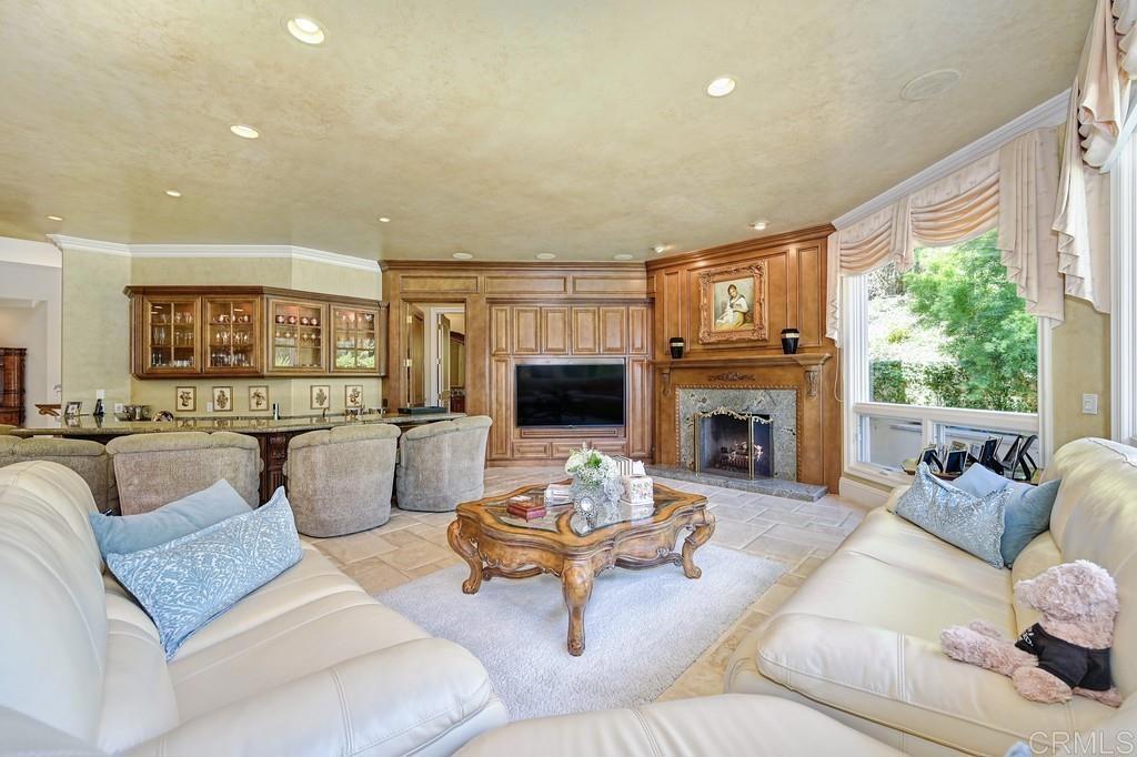 7210 Aviara Drive Carlsbad, CA 92011 - Photo 19 of 63 a living room with furniture fireplace and a large window