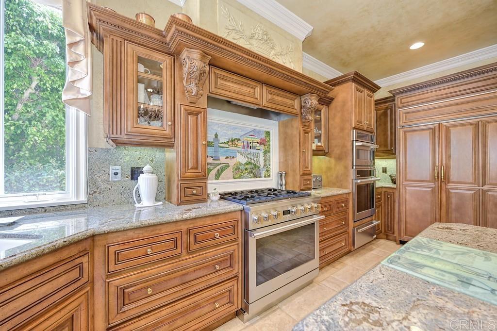 7210 Aviara Drive Carlsbad, CA 92011 - Photo 22 of 63 a kitchen with granite countertop cabinets stainless steel appliances and a counter space