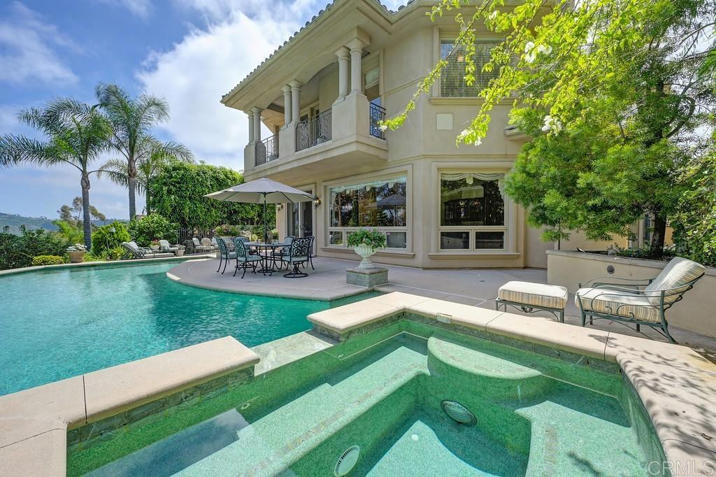 7210 Aviara Drive Carlsbad, CA 92011 - Photo 4 of 63 a front view of a house with garden and a chairs