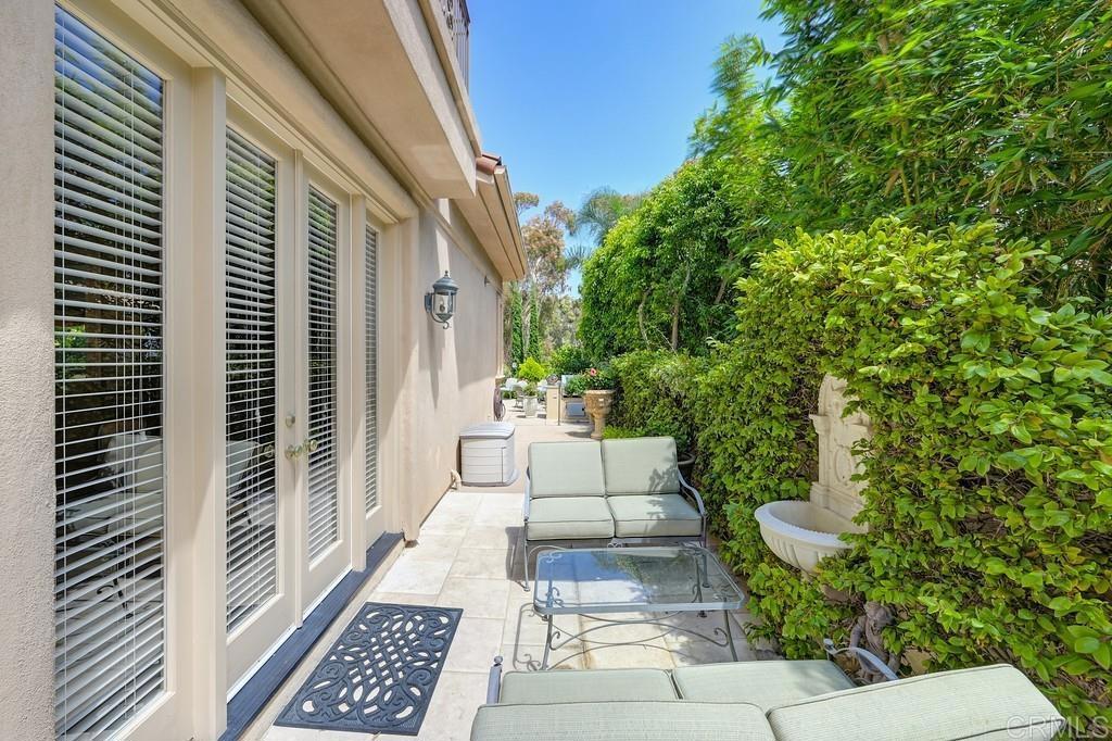 7210 Aviara Drive Carlsbad, CA 92011 - Photo 51 of 63 a view of a patio with table and chairs and potted plants