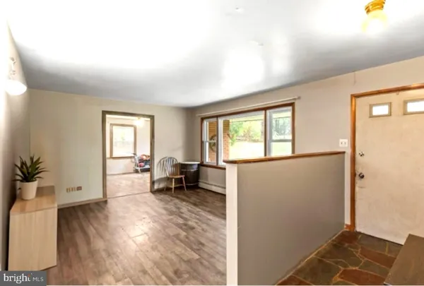a view of a livingroom with furniture and a window