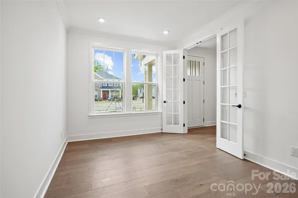 an empty room with large windows