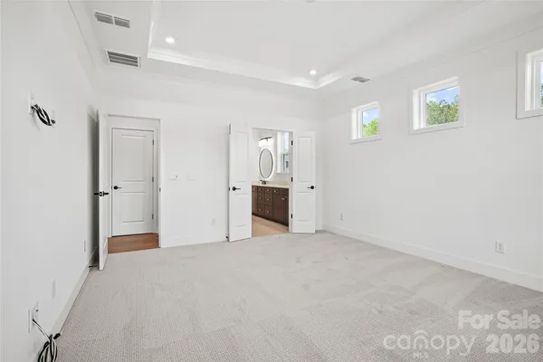 a view of a big room with wooden floor and windows