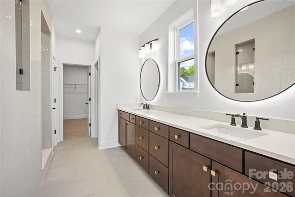 a bathroom with a double vanity sink and a mirror