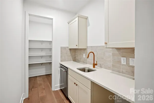 a kitchen with a sink cabinets and a window