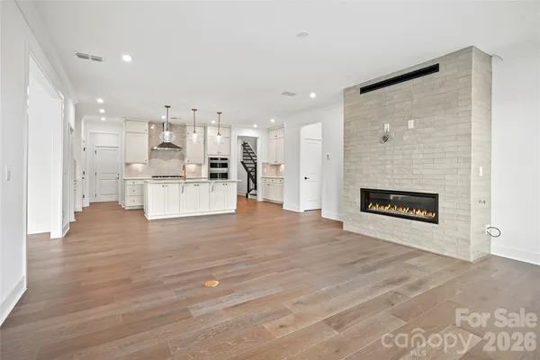 a view of kitchen and kitchen with furniture wooden floor and window