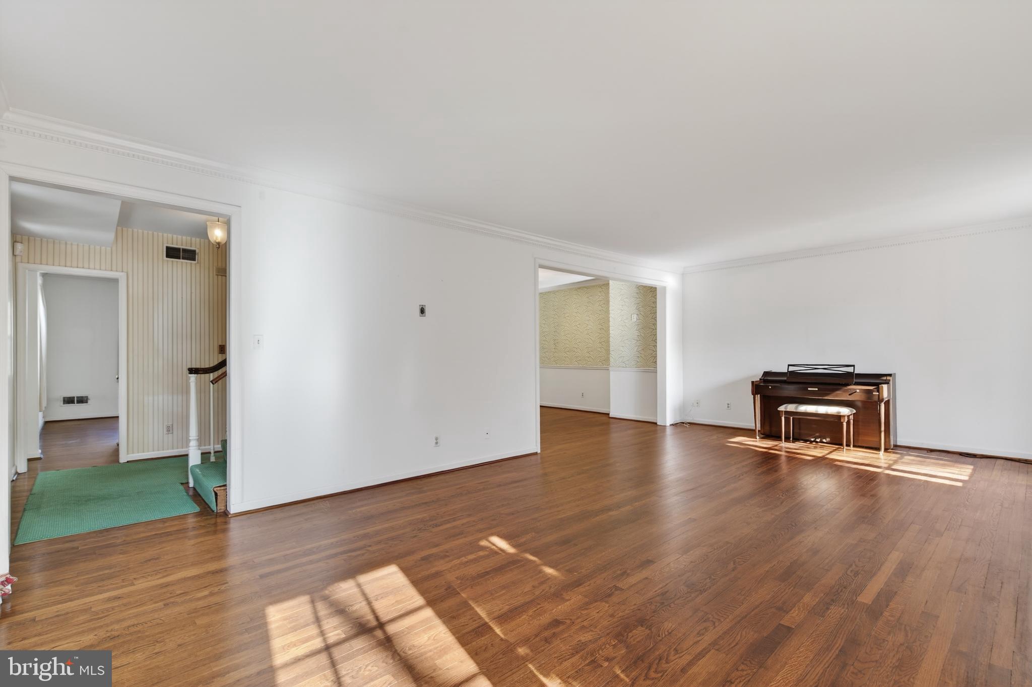 3512 Hamlet Place Chevy Chase, MD 20815 - Photo 11 of 51 a view of an empty room with wooden floor and a window