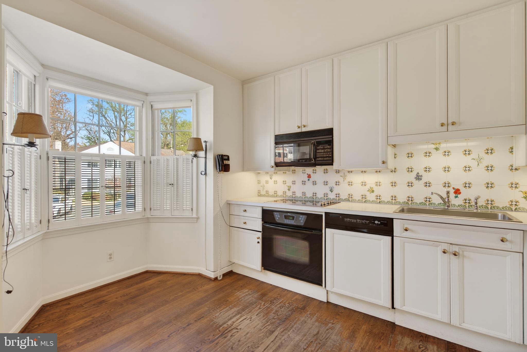 3512 Hamlet Place Chevy Chase, MD 20815 - Photo 17 of 51 a kitchen with granite countertop white cabinets and white appliances