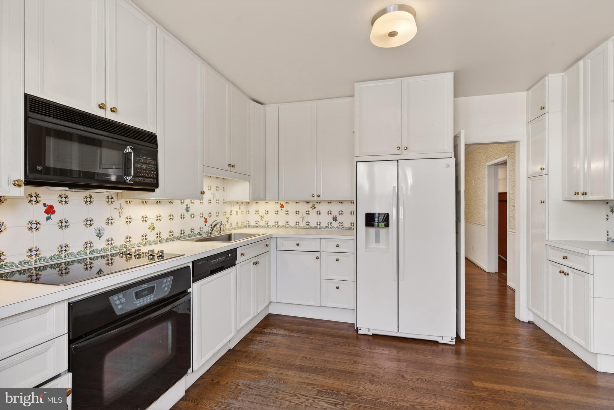 3512 Hamlet Place Chevy Chase, MD 20815 - Photo 20 of 51 a kitchen with granite countertop cabinets stainless steel appliances and wooden floor
