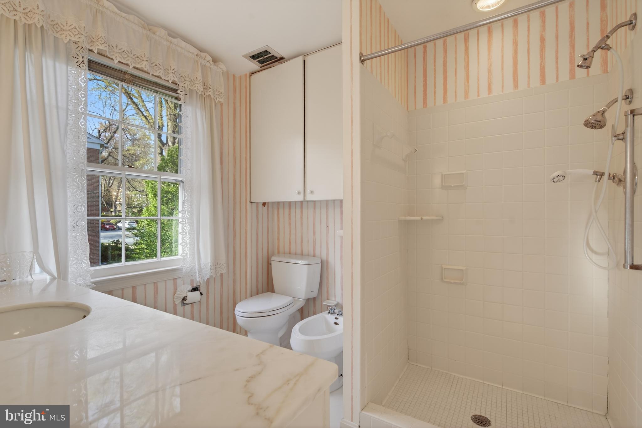 3512 Hamlet Place Chevy Chase, MD 20815 - Photo 29 of 51 a bathroom with a shower curtain and a window