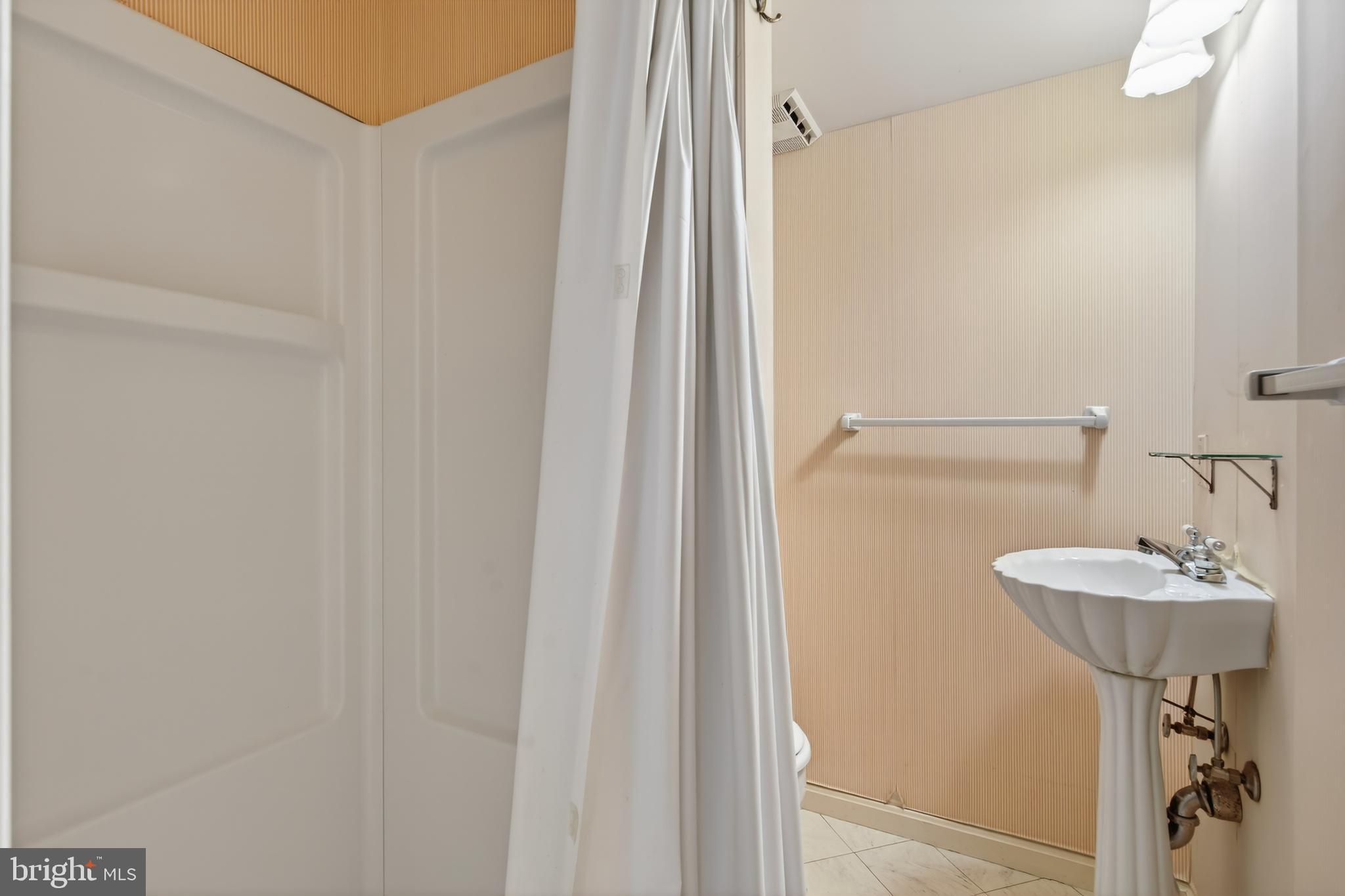 3512 Hamlet Place Chevy Chase, MD 20815 - Photo 41 of 51 a bathroom with a sink a mirror and a shower