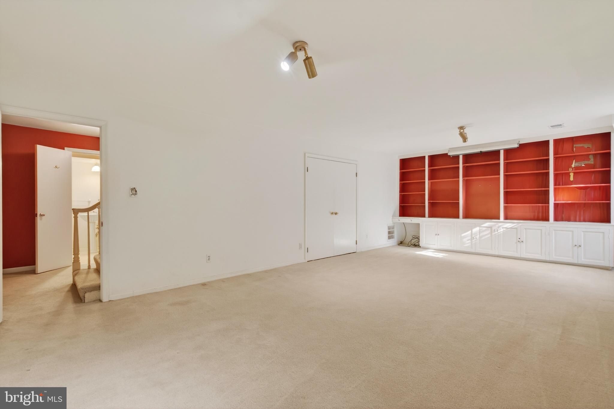 3512 Hamlet Place Chevy Chase, MD 20815 - Photo 43 of 51 an empty room with a empty shelves and natural light