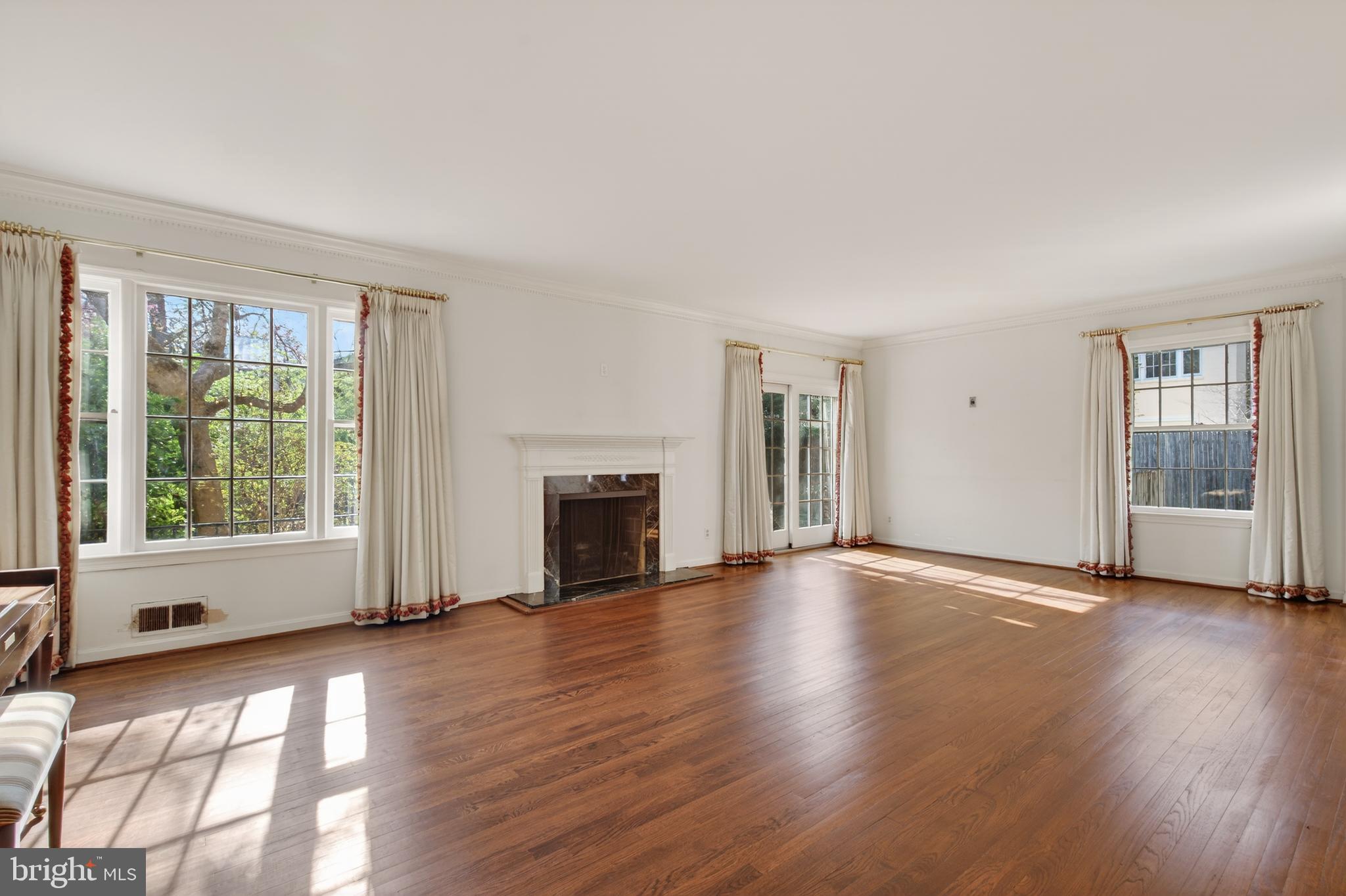 3512 Hamlet Place Chevy Chase, MD 20815 - Photo 9 of 51 a view of empty room with wooden floor and fireplace