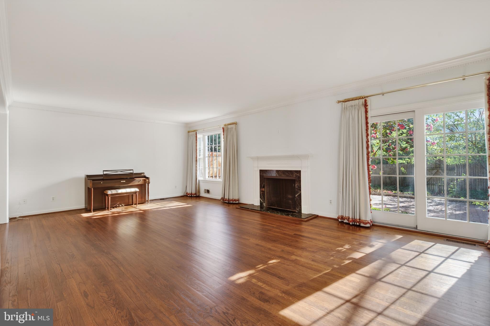 3512 Hamlet Place Chevy Chase, MD 20815 - Photo 10 of 51 a view of empty room with wooden floor and fireplace