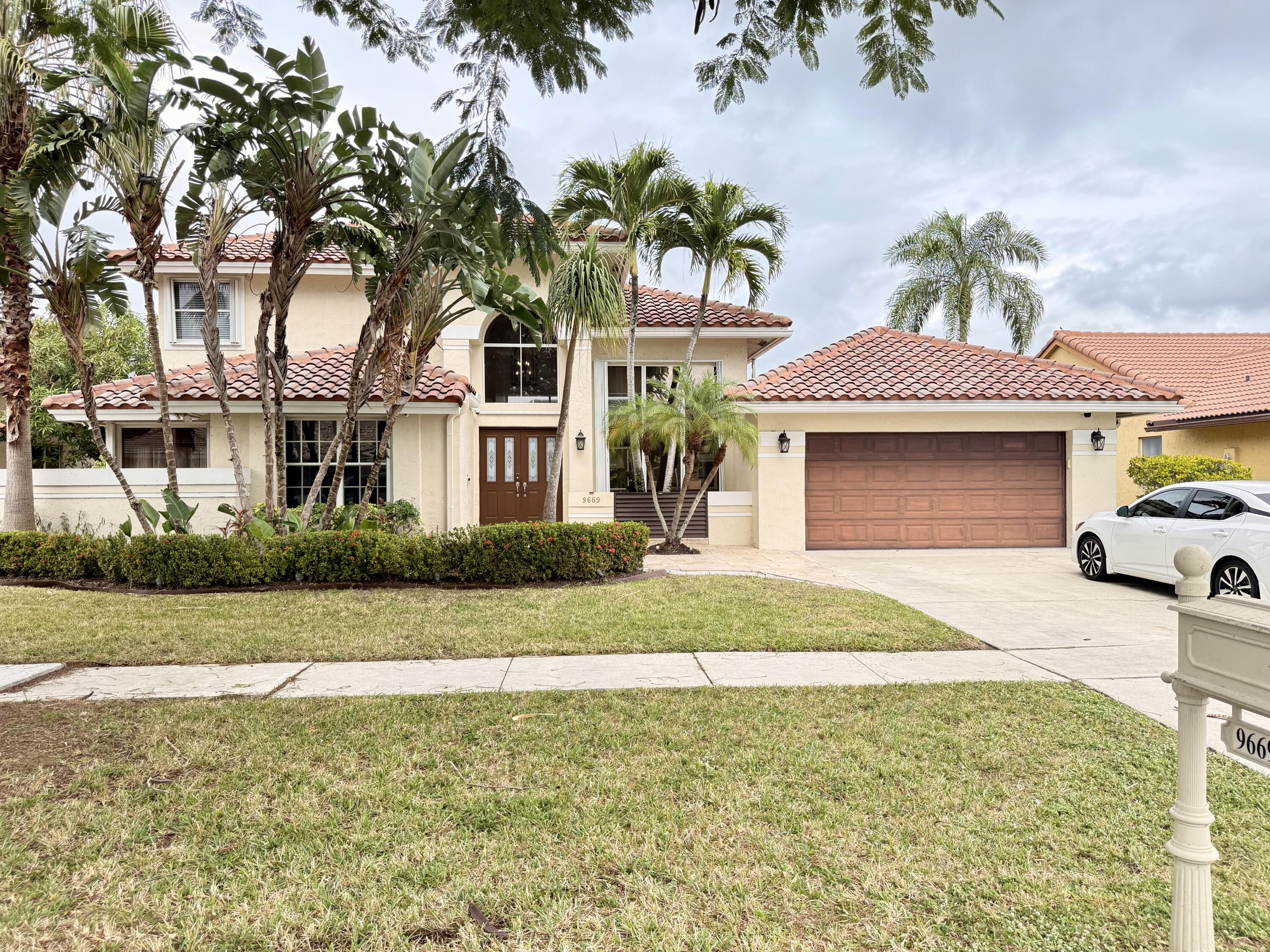 9669 Carousel Circle North Boca Raton, FL 33434 - Photo 21 of 22 a front view of a house with garden
