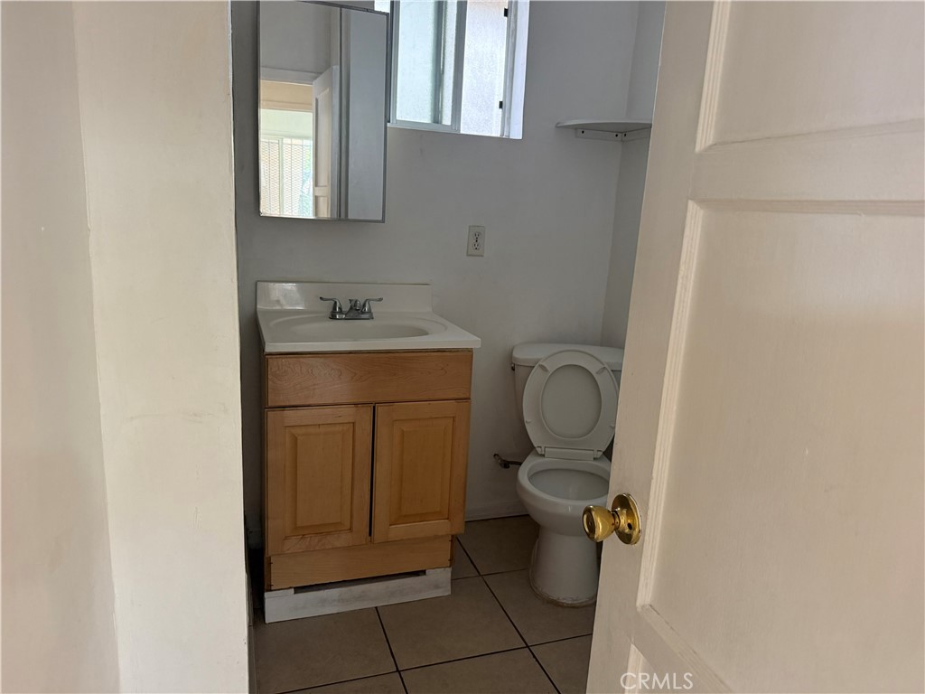 1946 Bryce Road South El Monte, CA 91733 - Photo 6 of 9 a bathroom with a granite countertop toilet sink and mirror