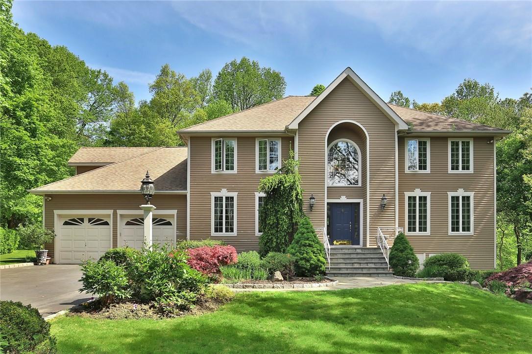 Gracious Center Hall Colonial on private, beautifully landscaped park-like, one acre property, in Cortlandt Manor.