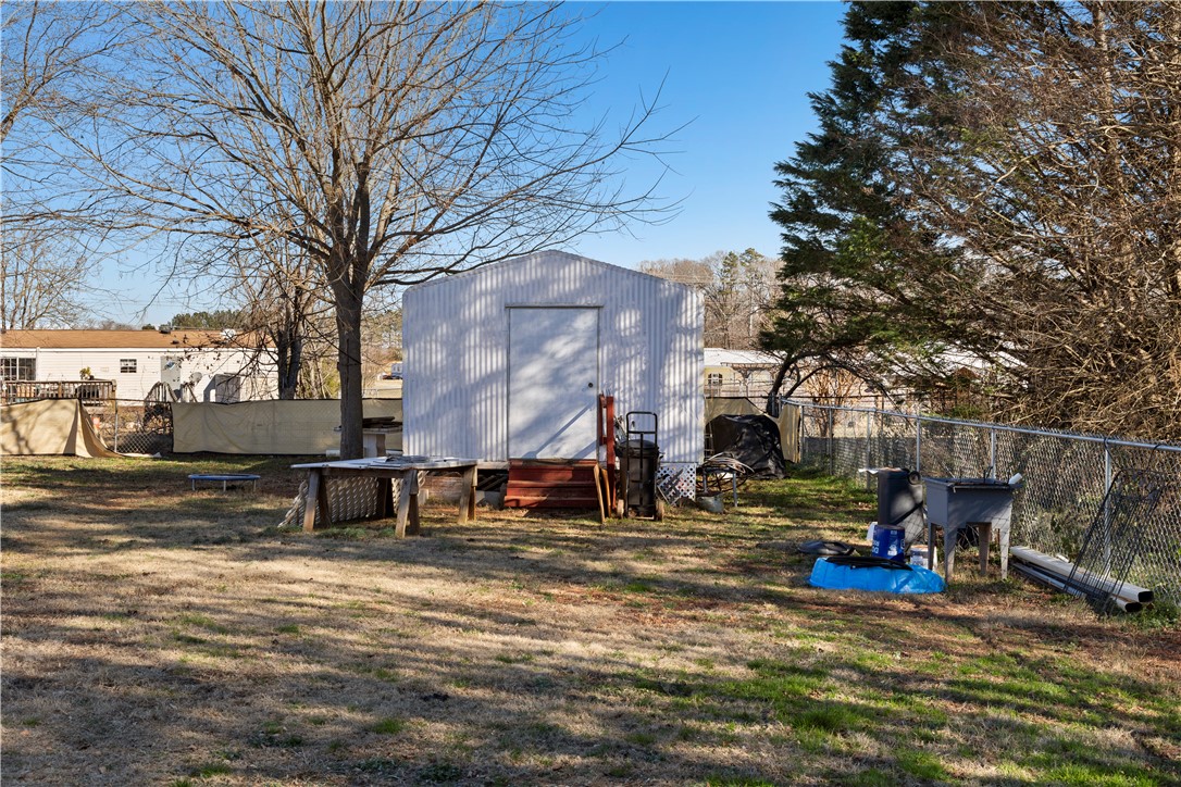 811 Pine Grove Road Seneca, SC 29678 - Photo 16 of 20 This spacious yard offers ample outdoor living space and includes a practical storage shed.