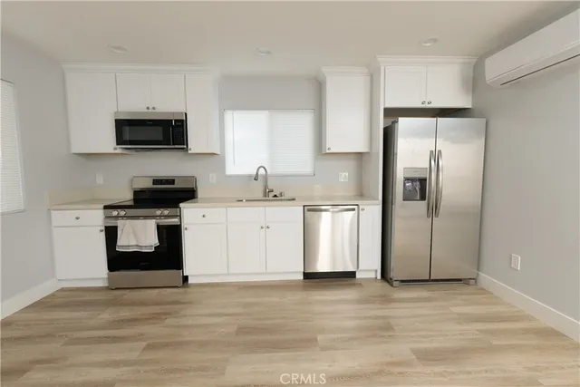 a kitchen with stainless steel appliances a refrigerator stove and microwave