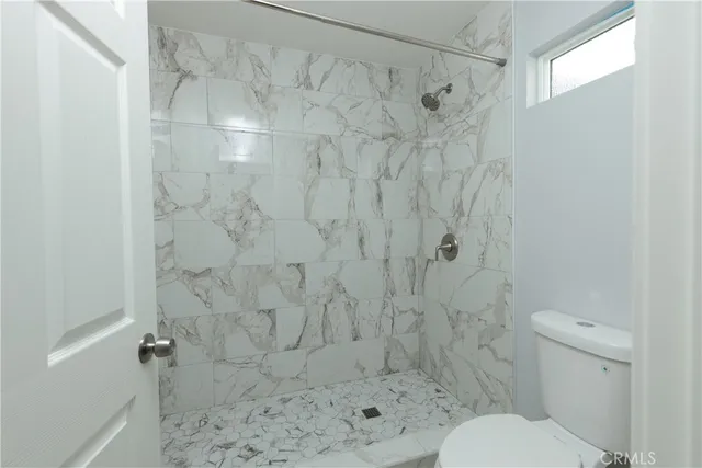 a bathroom with a toilet and shower