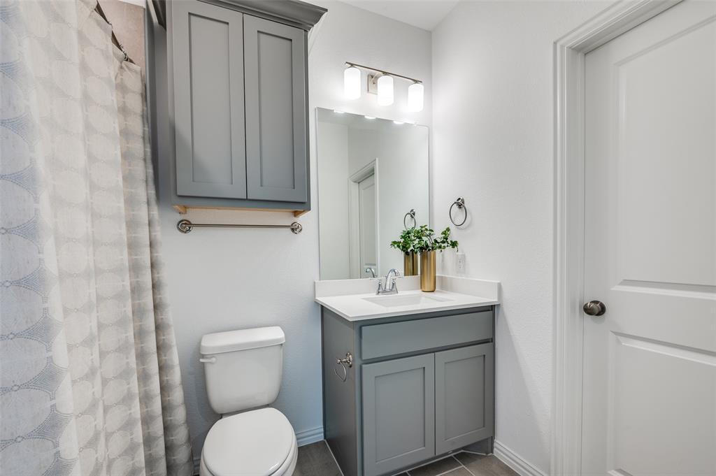 3718 Pelican Rst Way Arlington, TX 76005 - Photo 17 of 37 a bathroom with a toilet a sink and mirror