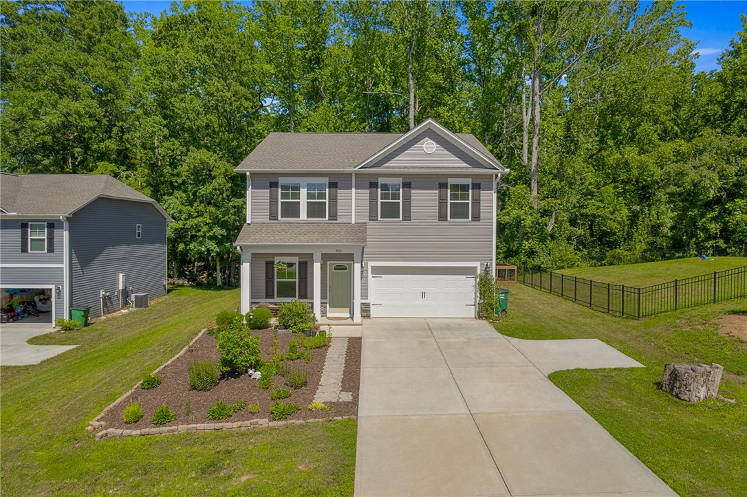 430 Johnson Road Central, SC 29630 - Photo 30 of 36 A classic gray-sided residence welcomes with a manicured front garden and an attached garage.
