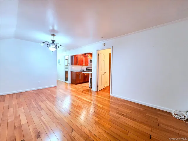 a view of a livingroom with wooden floor and a ceiling fan