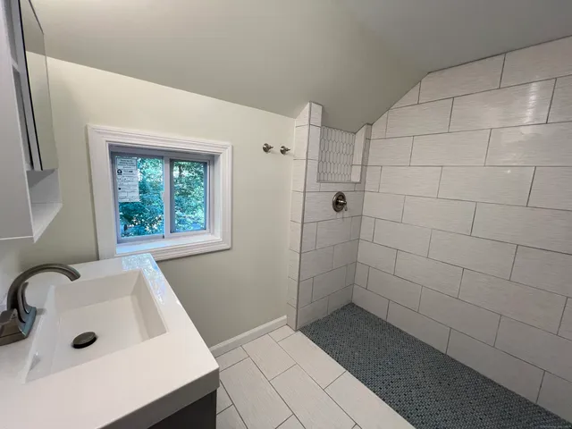a bathroom with a bathtub and shower