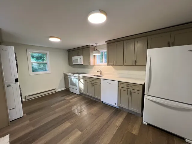 a kitchen with a refrigerator a sink and cabinets