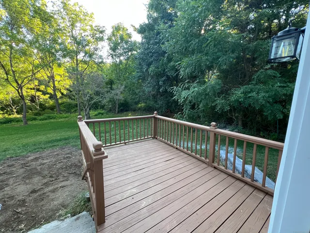 a wooden deck with sunset view
