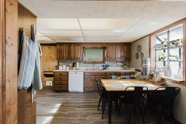 a kitchen with stainless steel appliances a stove a sink refrigerator and a refrigerator