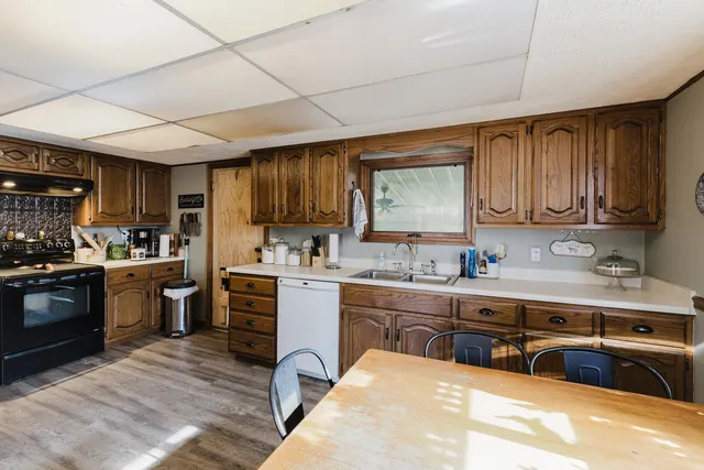 a kitchen with sink cabinets and window