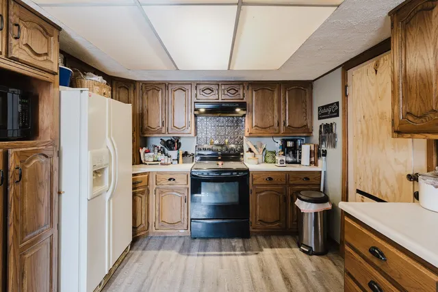 a kitchen with a refrigerator stove and sink