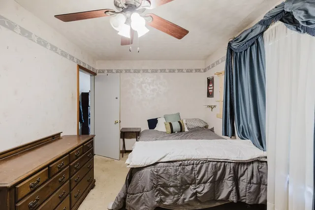 a bedroom with a bed and a chandelier