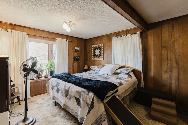 a bedroom with a bed and a window