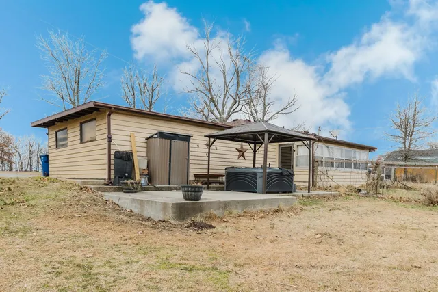 a front view of a house with a yard covered in snow