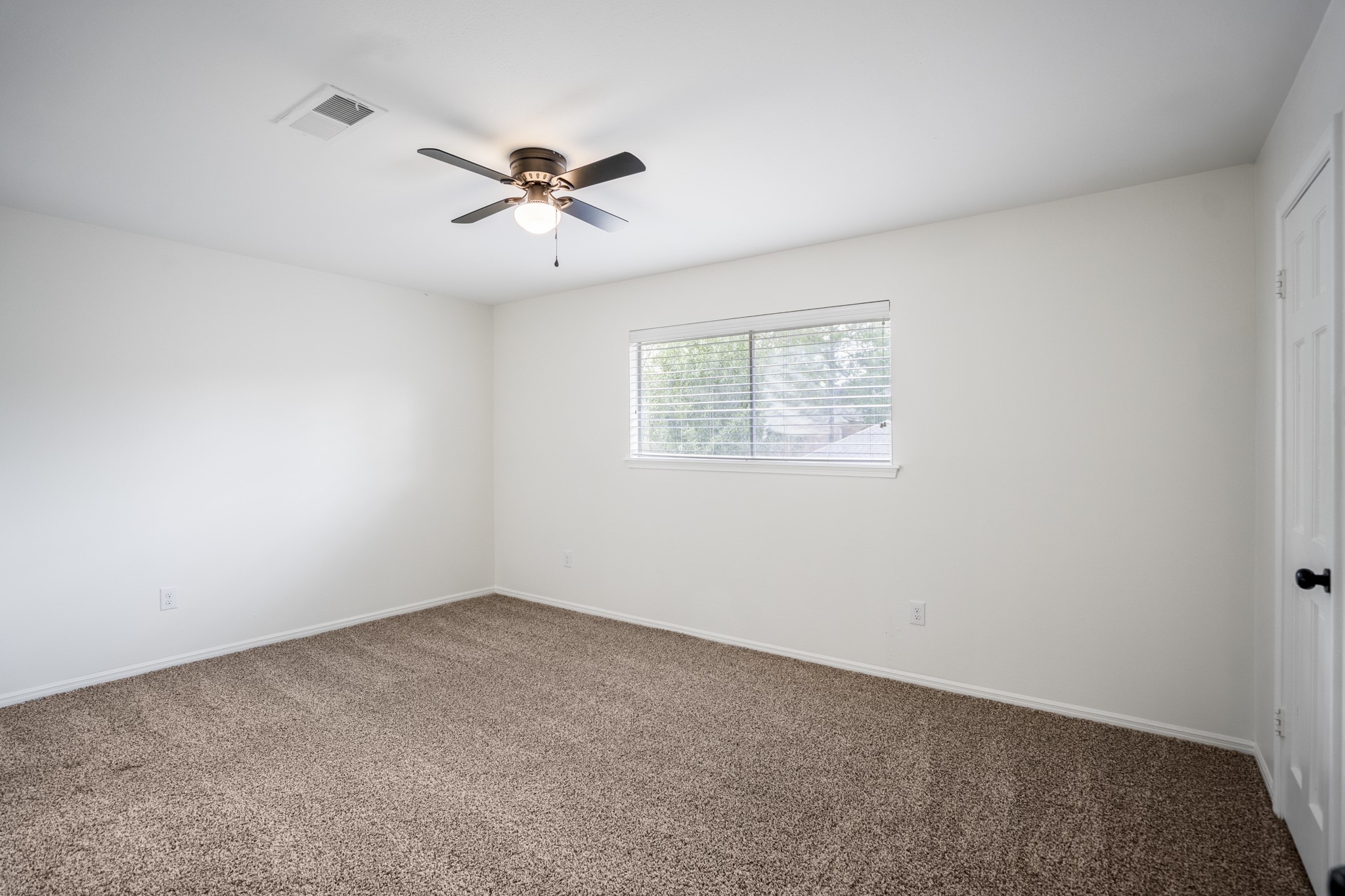 8006 Vickridge Lane Spring, TX 77379 - Photo 34 of 50 The third upstairs bedroom. This space features fresh carpet, updated lighting, and soft natural light as well as a "jack-and-jill style" bathroom connecting to the fourth bedroom.