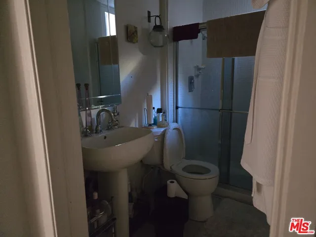 a bathroom with a sink toilet and a mirror