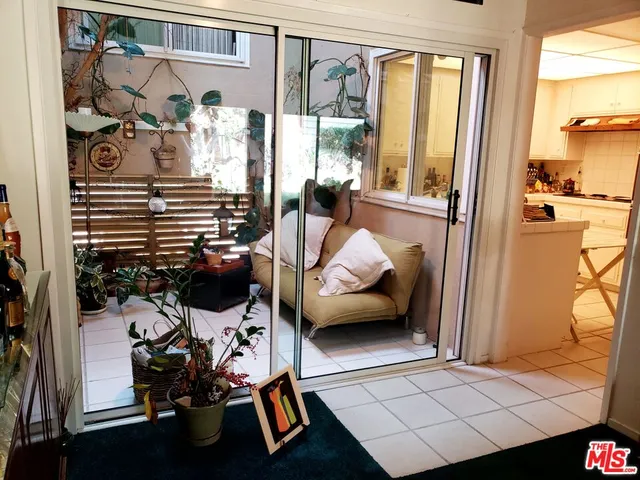 a view of a bedroom with furniture and a window