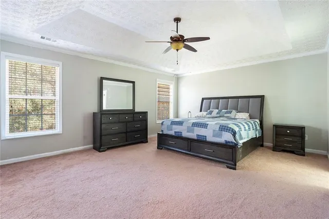 a bedroom with a bed and dresser with mirror