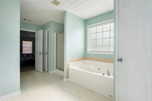 a bathroom with a bathtub and a shower
