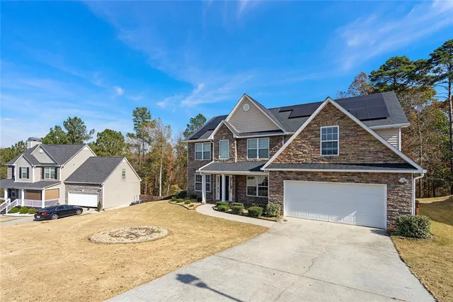 a front view of a house with a yard