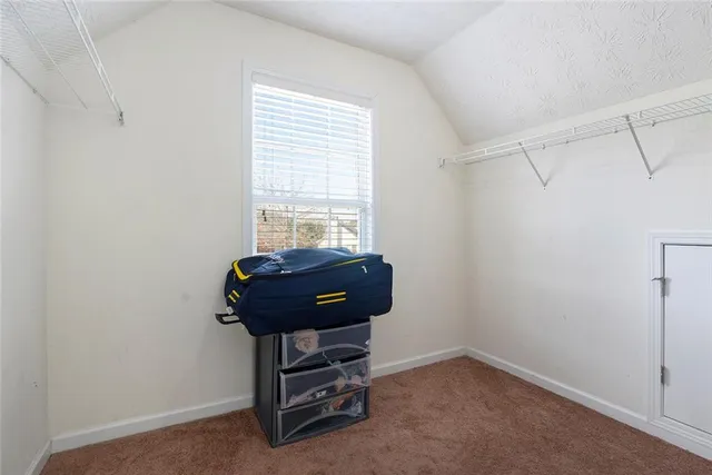 a room with a dresser and a window